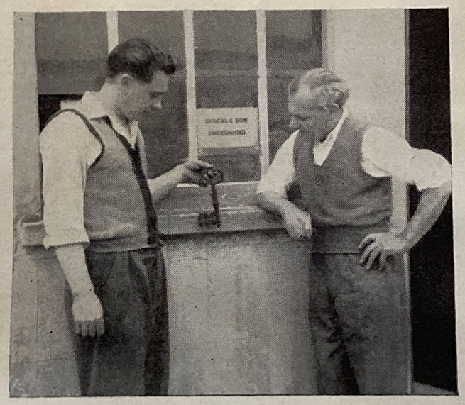 Ronald Edward Stokes fourth generation, with his father Edward Percival Stokes, third generation of locksmiths in the family, showcasing their trade sign